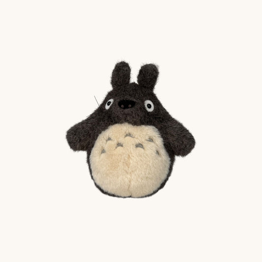 Stuffed toy resembling a character with a round body and long arms on a white background