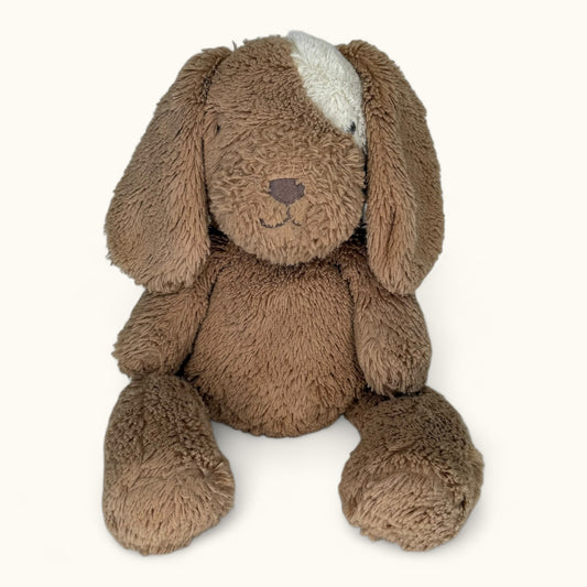 Brown plush dog toy on a white background
