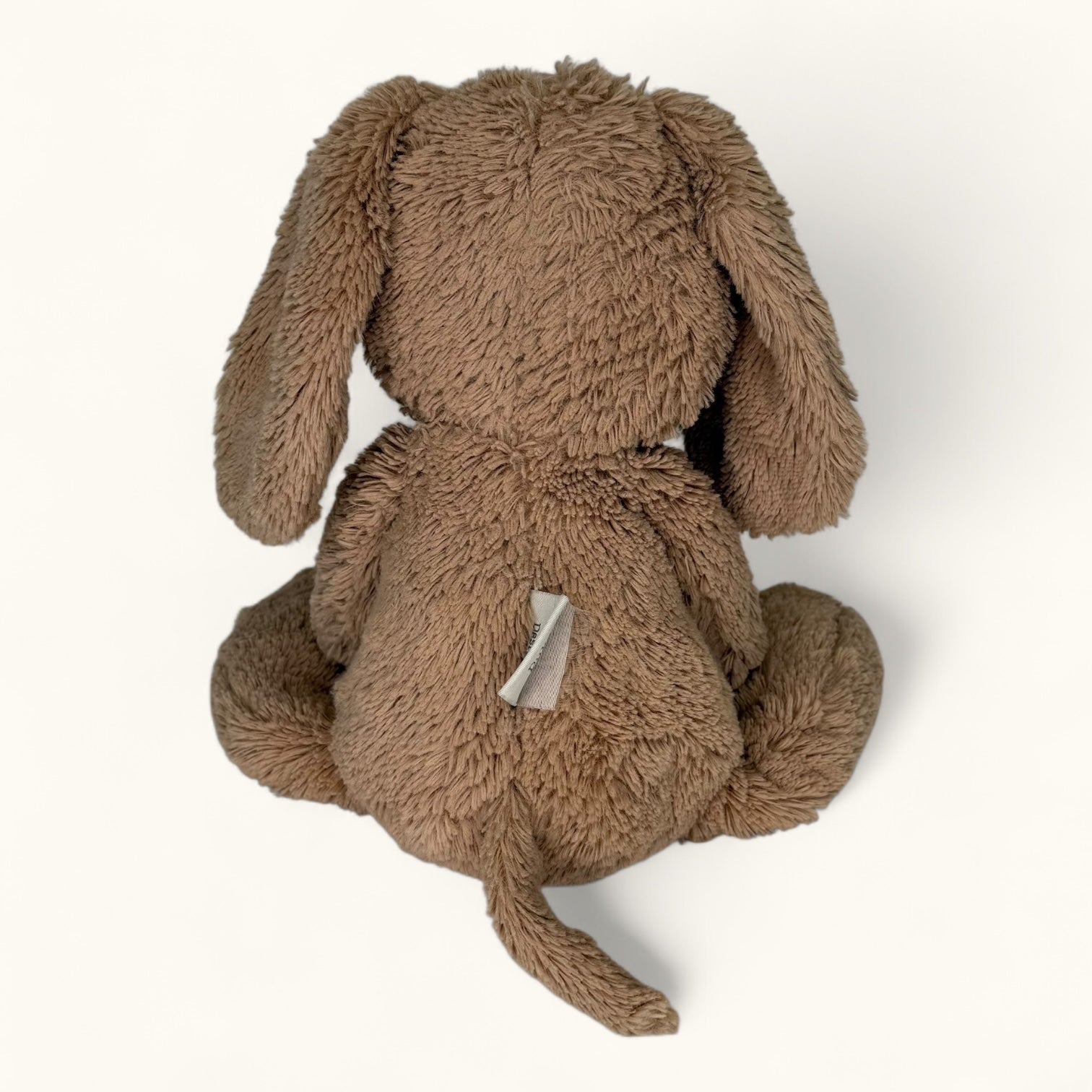 Brown plush bunny toy on a white background
