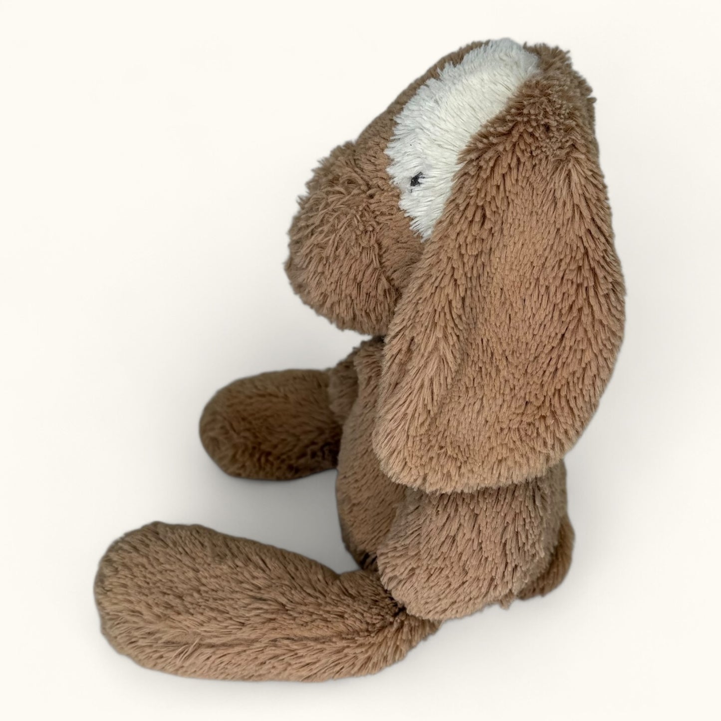 Brown plush toy with long ears on a white background