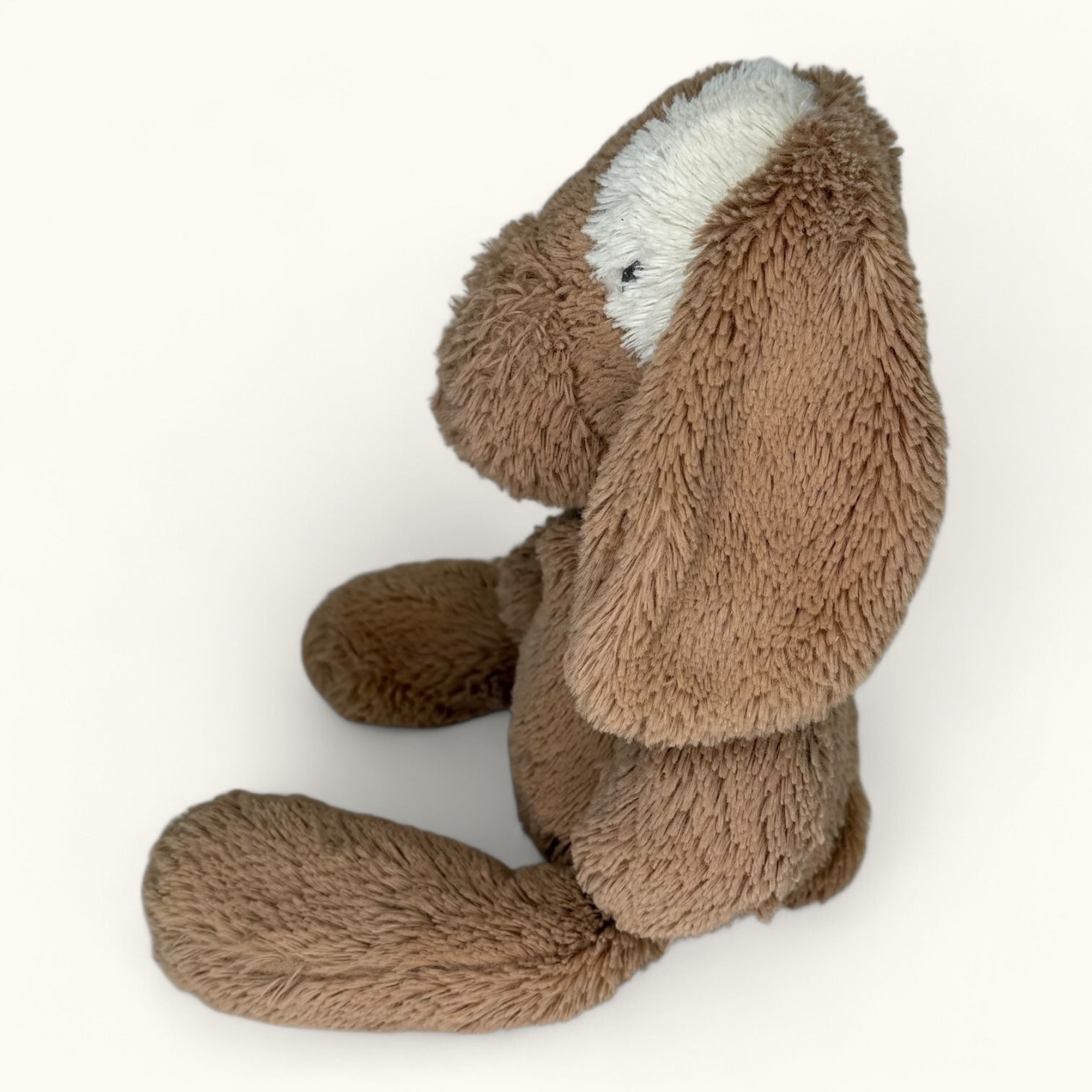 Brown plush toy with long ears on a white background