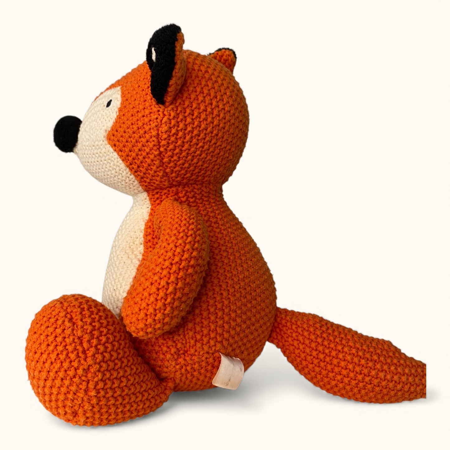 Knitted fox toy on a white background