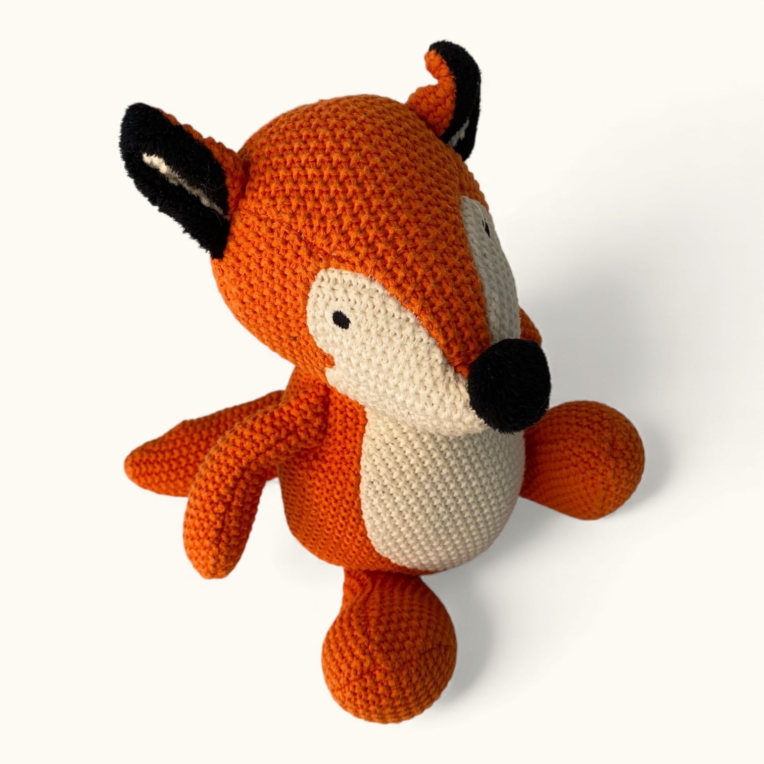 Knitted fox toy on a white background