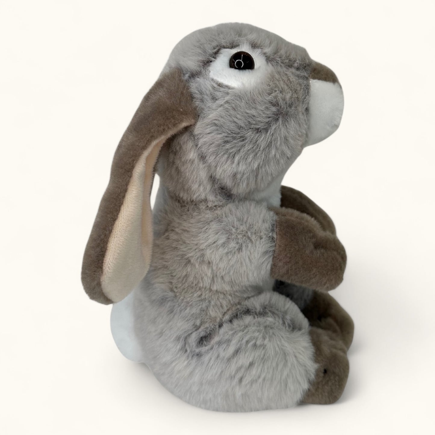 Plush toy rabbit with gray body and brown ears on a white background