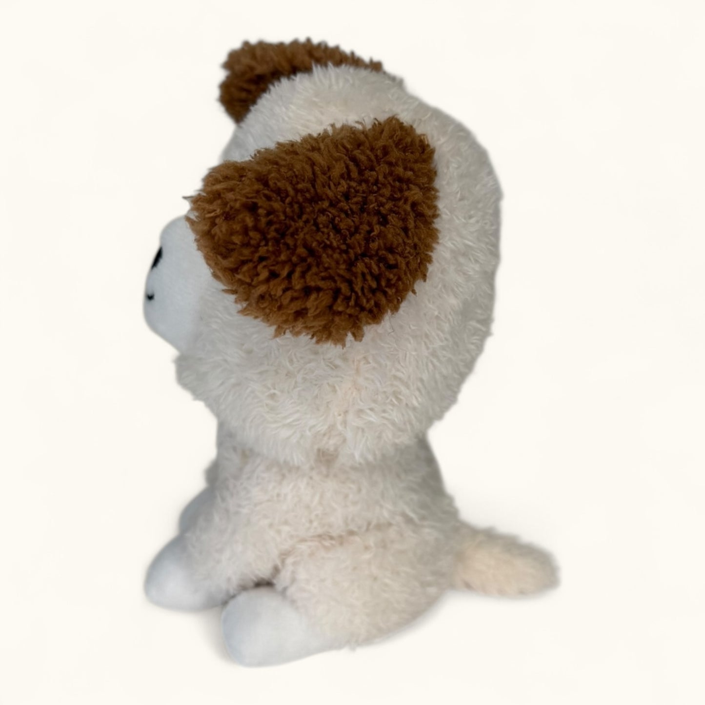 Plush toy resembling a dog with brown ears on a white background