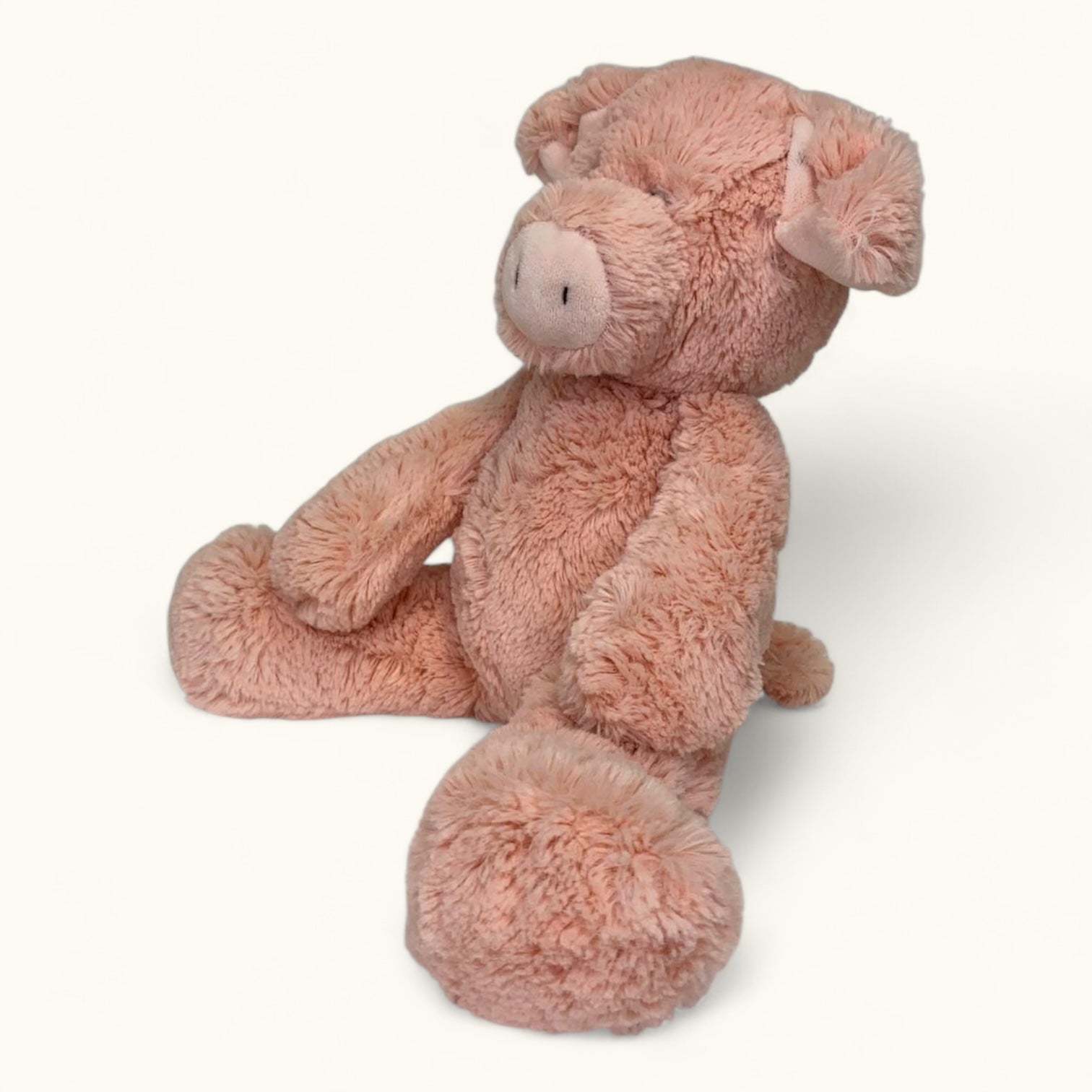 Pink plush toy pig on a white background