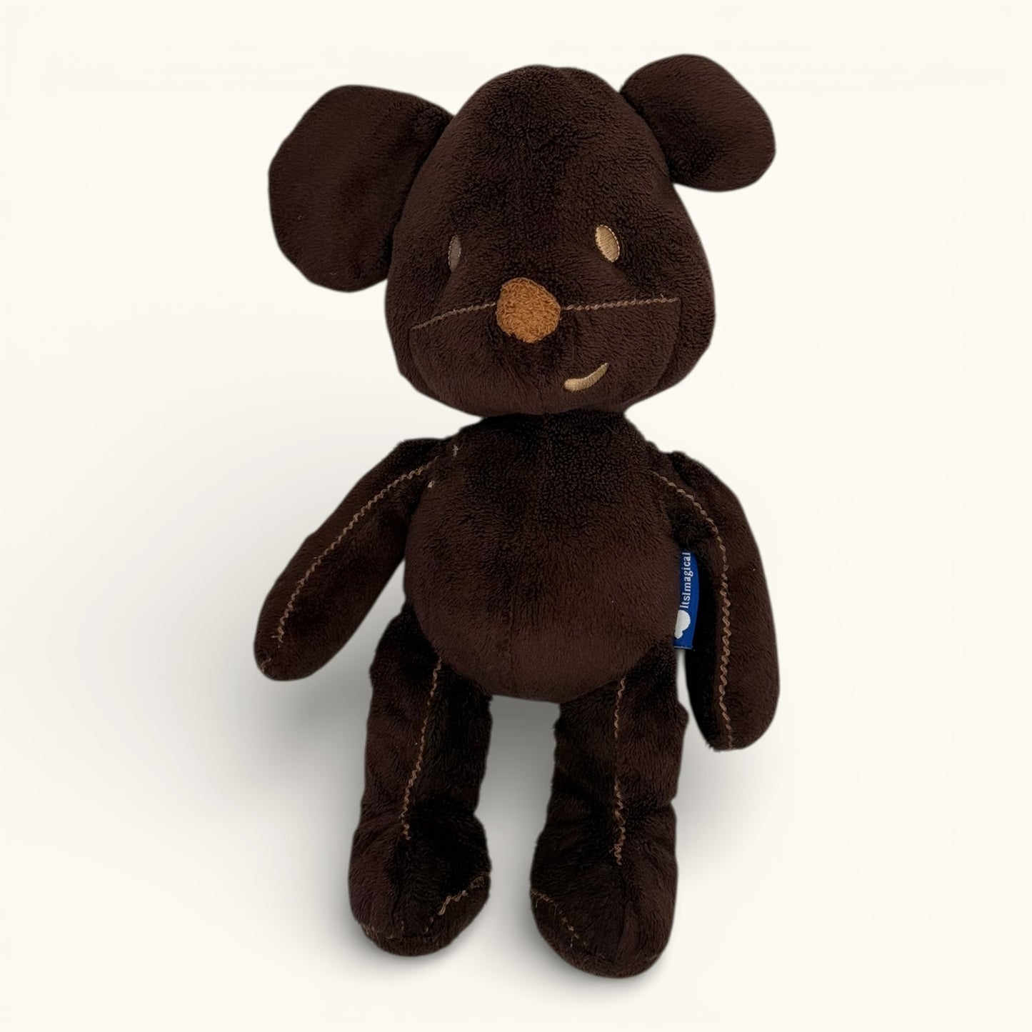Brown plush toy with a smiley face on a white background