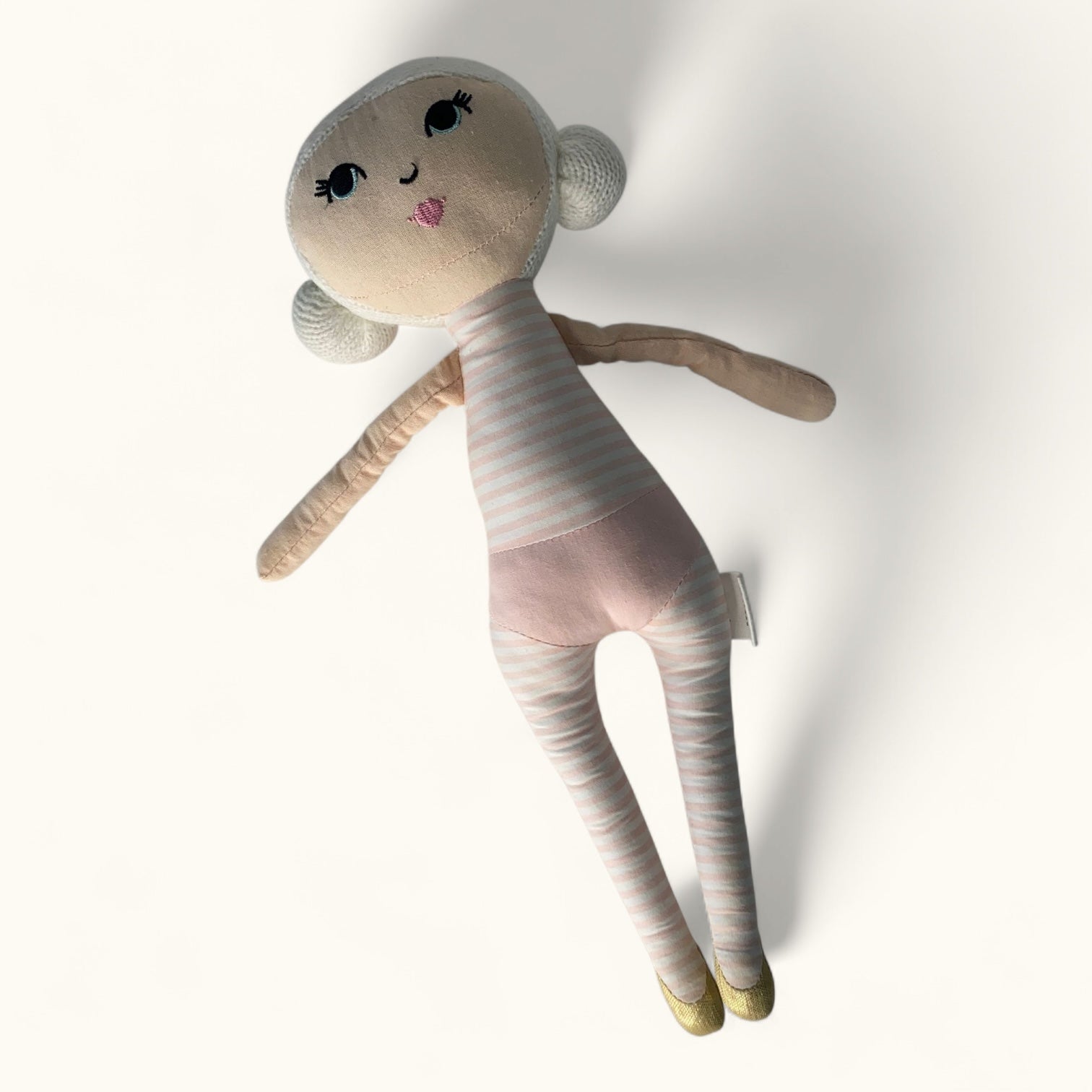 Stuffed toy doll with a plain background
