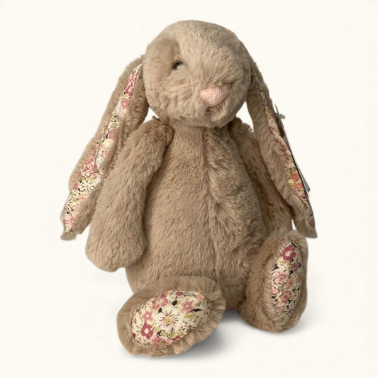 Floral-patterned plush rabbit toy on a white background