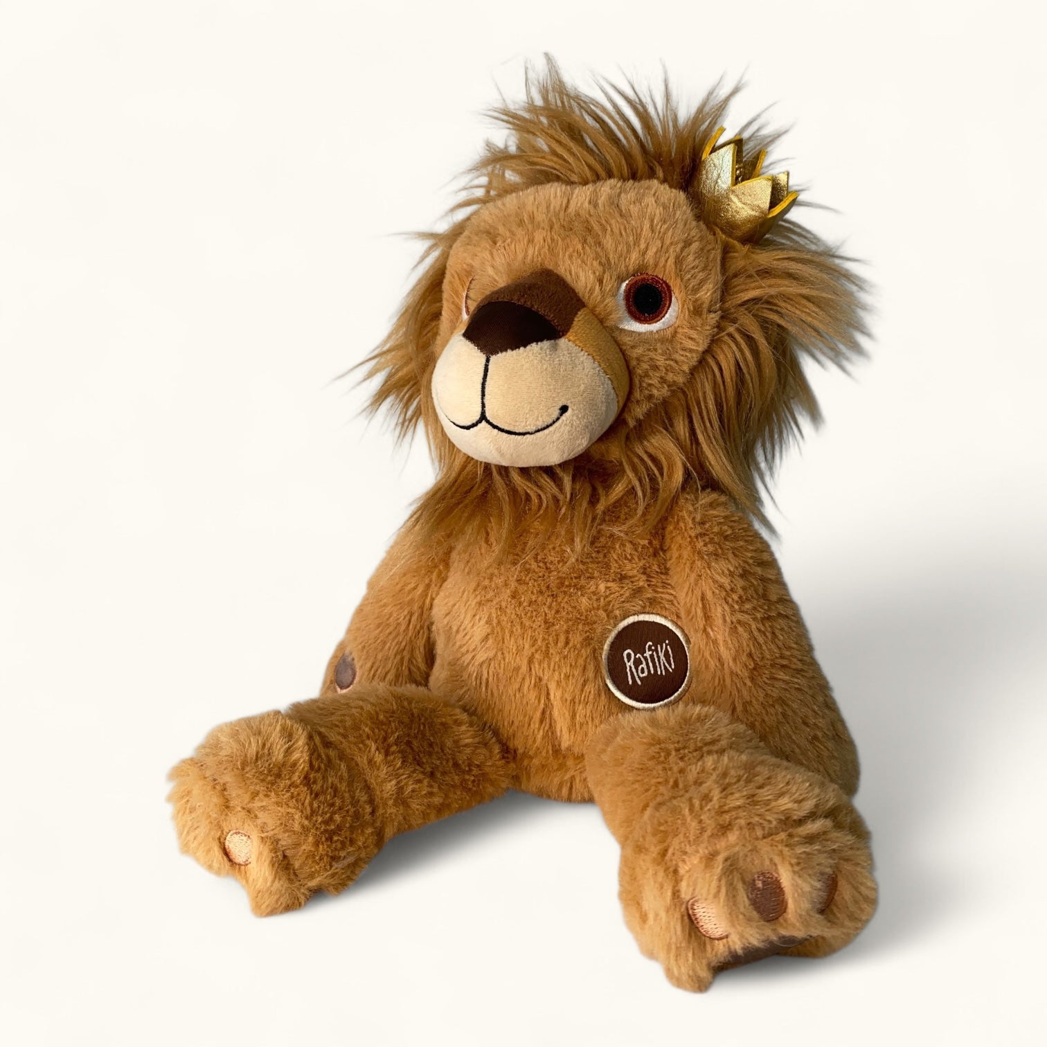 Plush lion toy with a crown on a white background