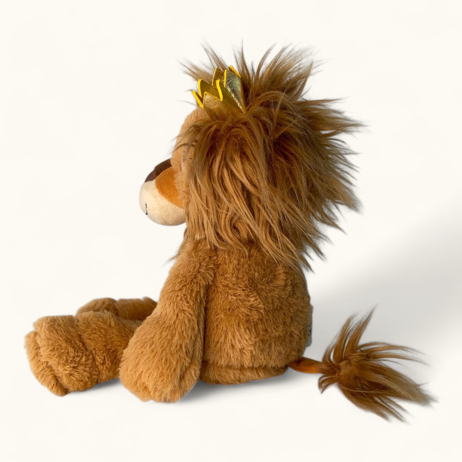 Plush lion toy with a yellow mane on a white background