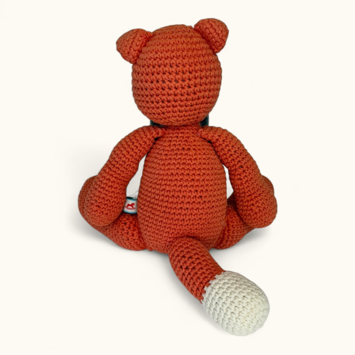 Crocheted fox toy on a white background