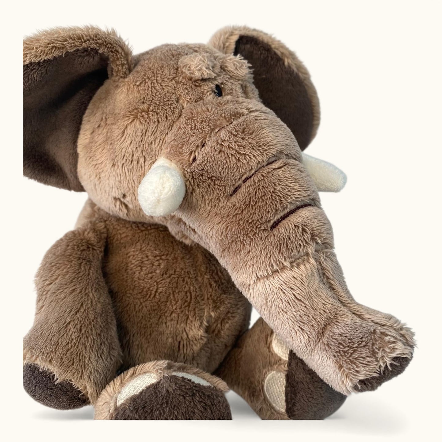 Plush elephant toy on a white background