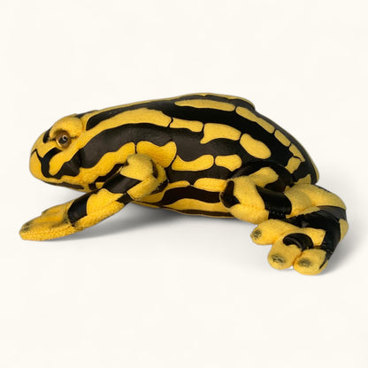 Plush toy frog with black and yellow pattern on a white background
