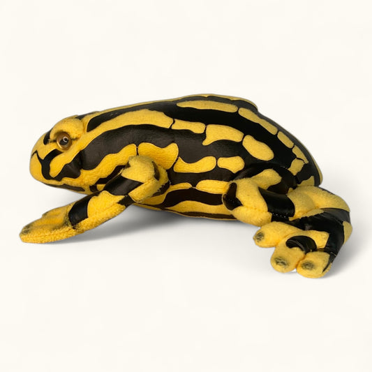 Plush toy frog with black and yellow pattern on a white background