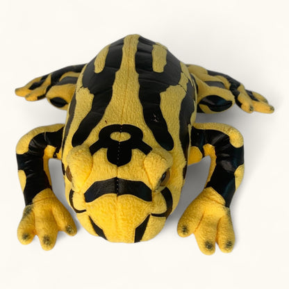 Plush toy frog with black and yellow pattern on a white background