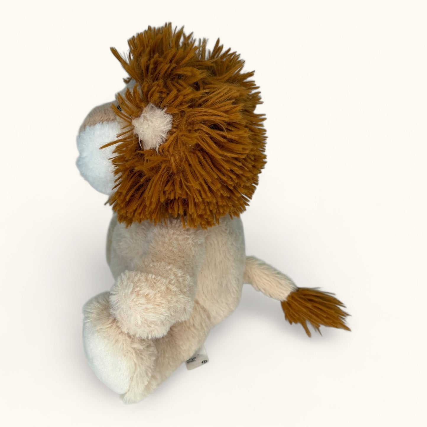 Plush lion toy on a white background