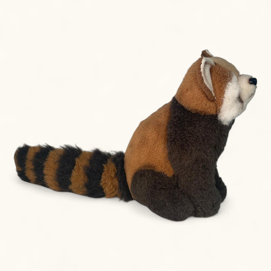 Plush toy red panda on a white background