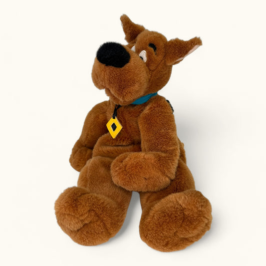 Plush toy resembling a cartoon character with a yellow tag on a white background