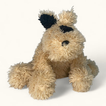 Plush toy resembling a dog with black ears on a white background