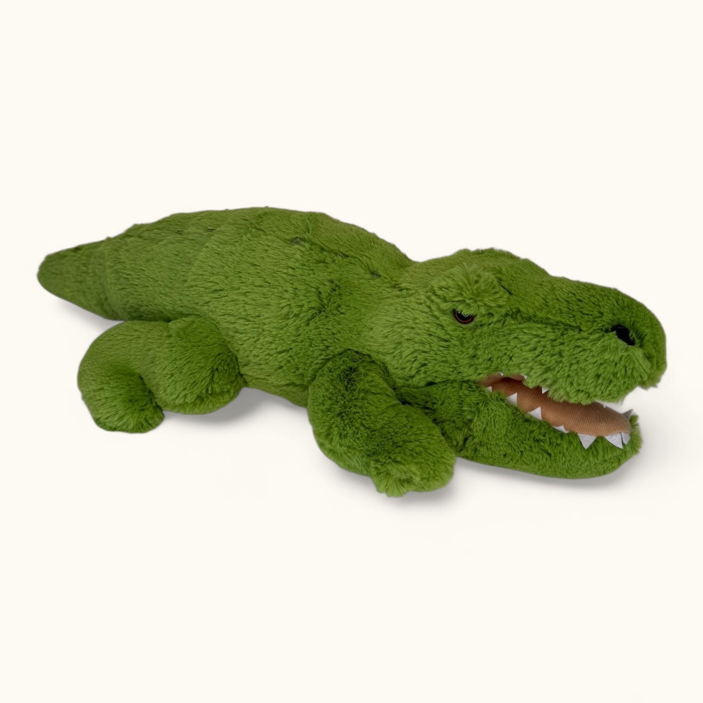 Green plush toy alligator on a white background