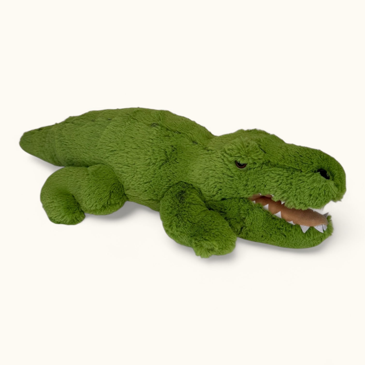 Green plush toy alligator on a white background