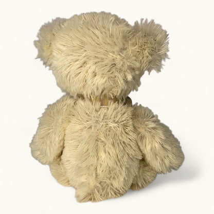 Beige teddy bear from behind on a white background