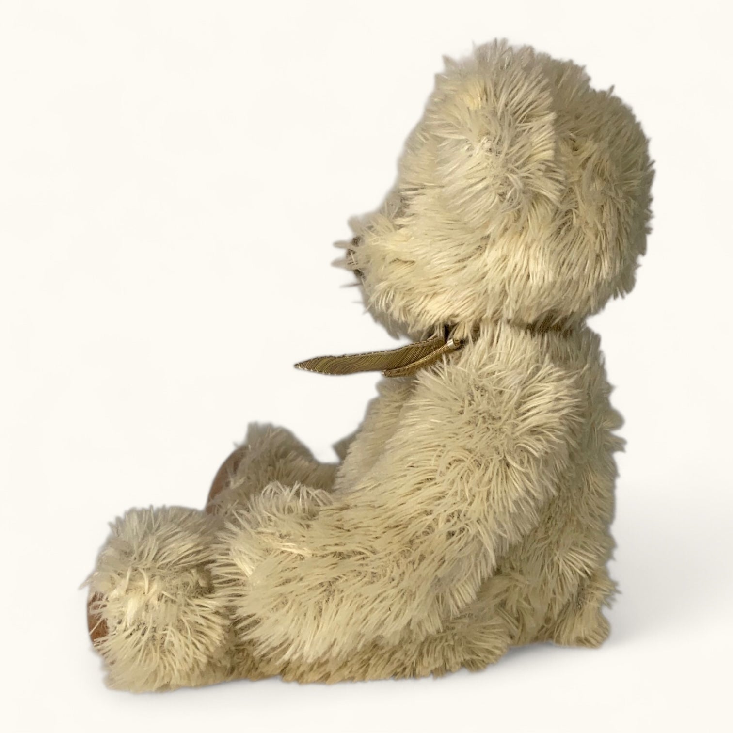 Beige plush teddy toy on a white background