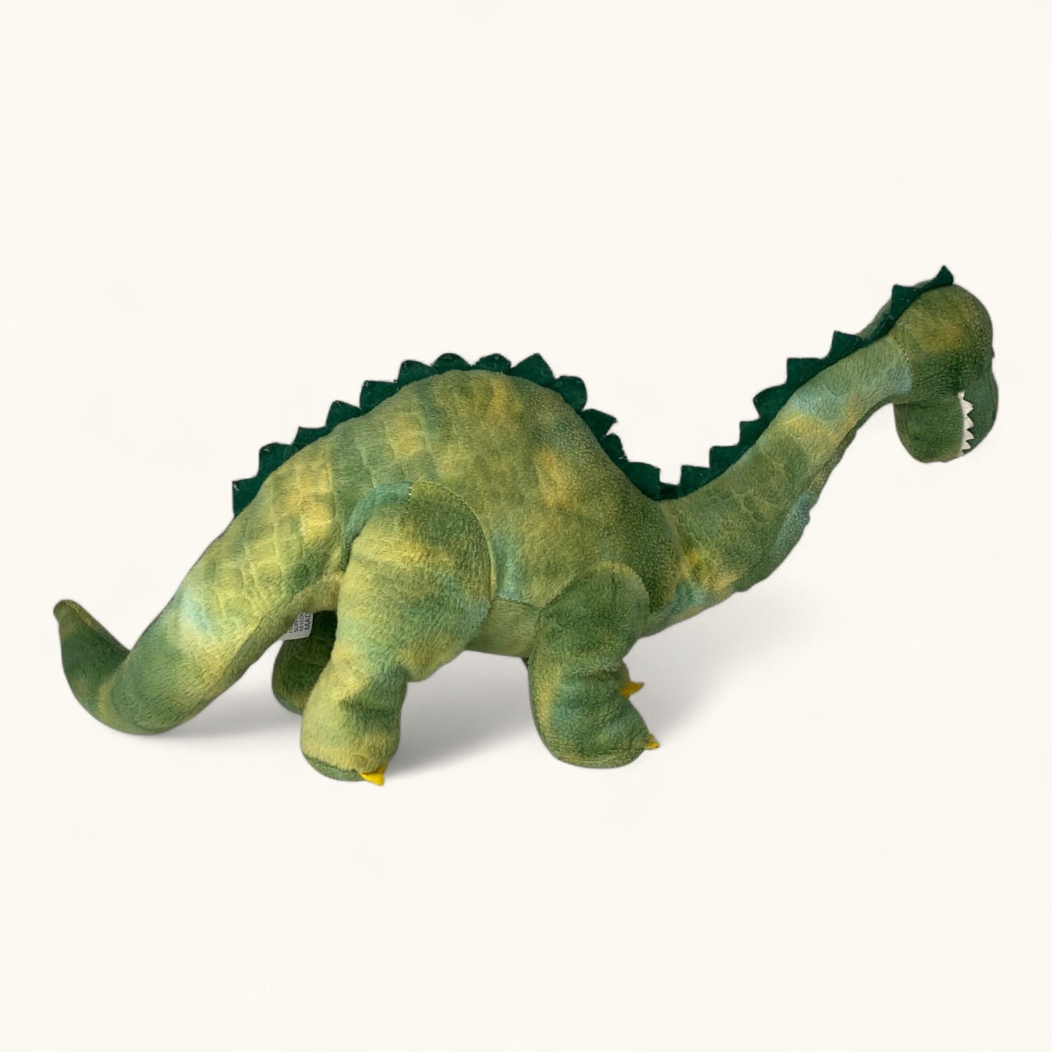 Plush dinosaur toy on a white background