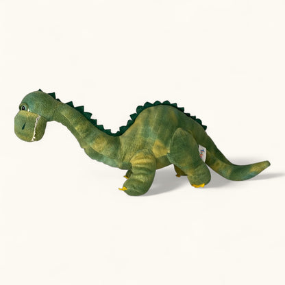 Green plush dinosaur toy on a white background