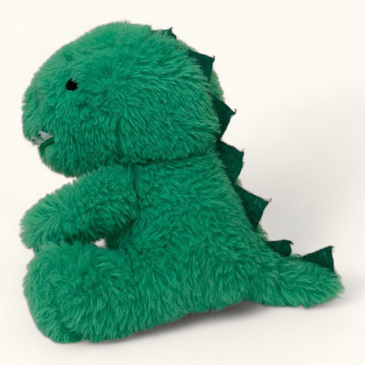 Green plush dinosaur toy on a white background