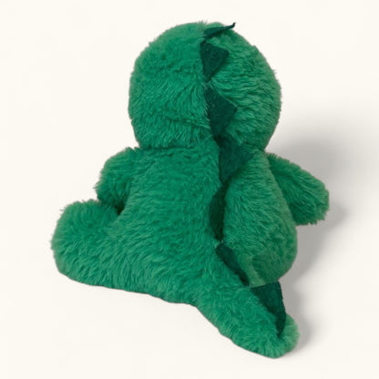 Green plush toy on a white background