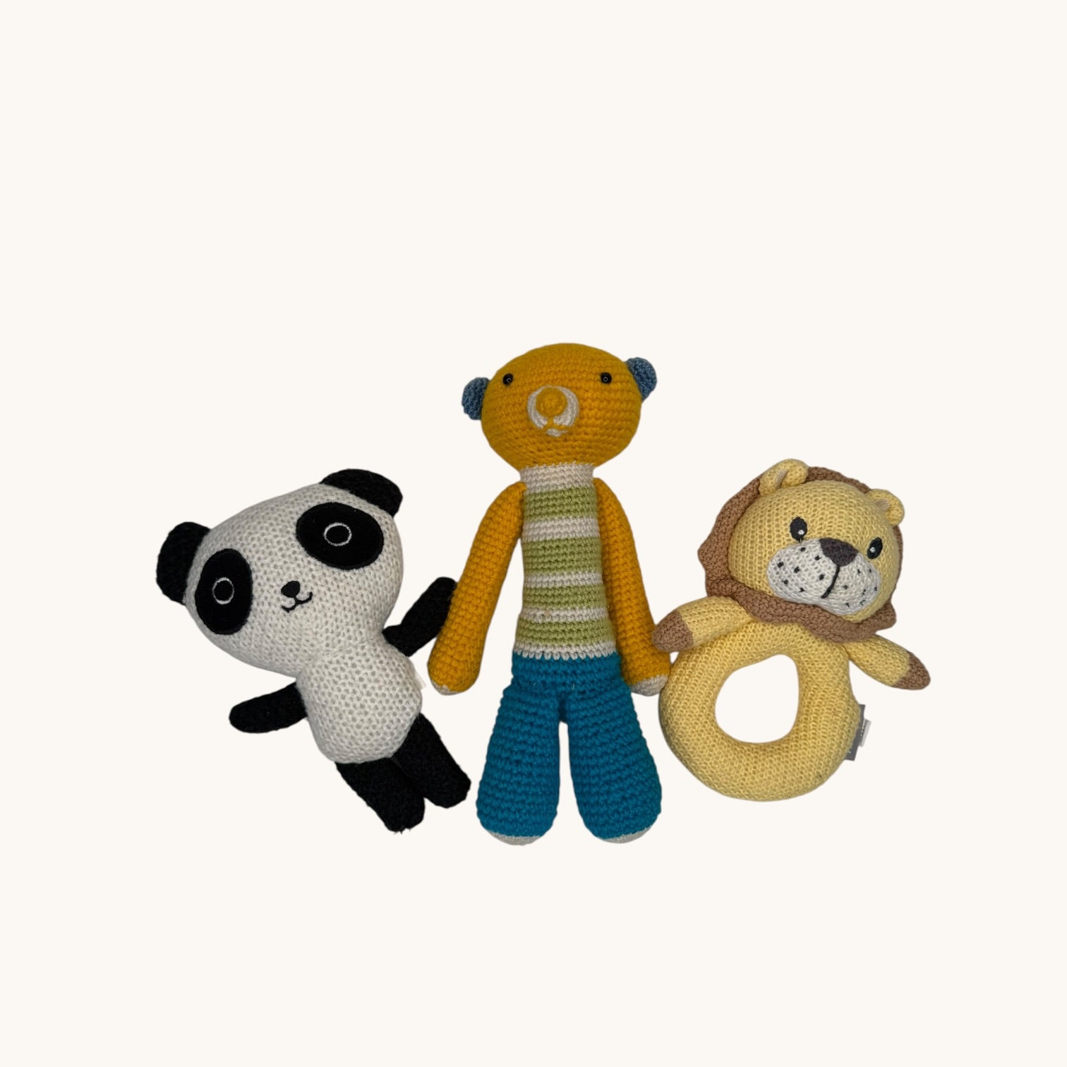 Three crochet toys including a panda, bear, and lion on a white background