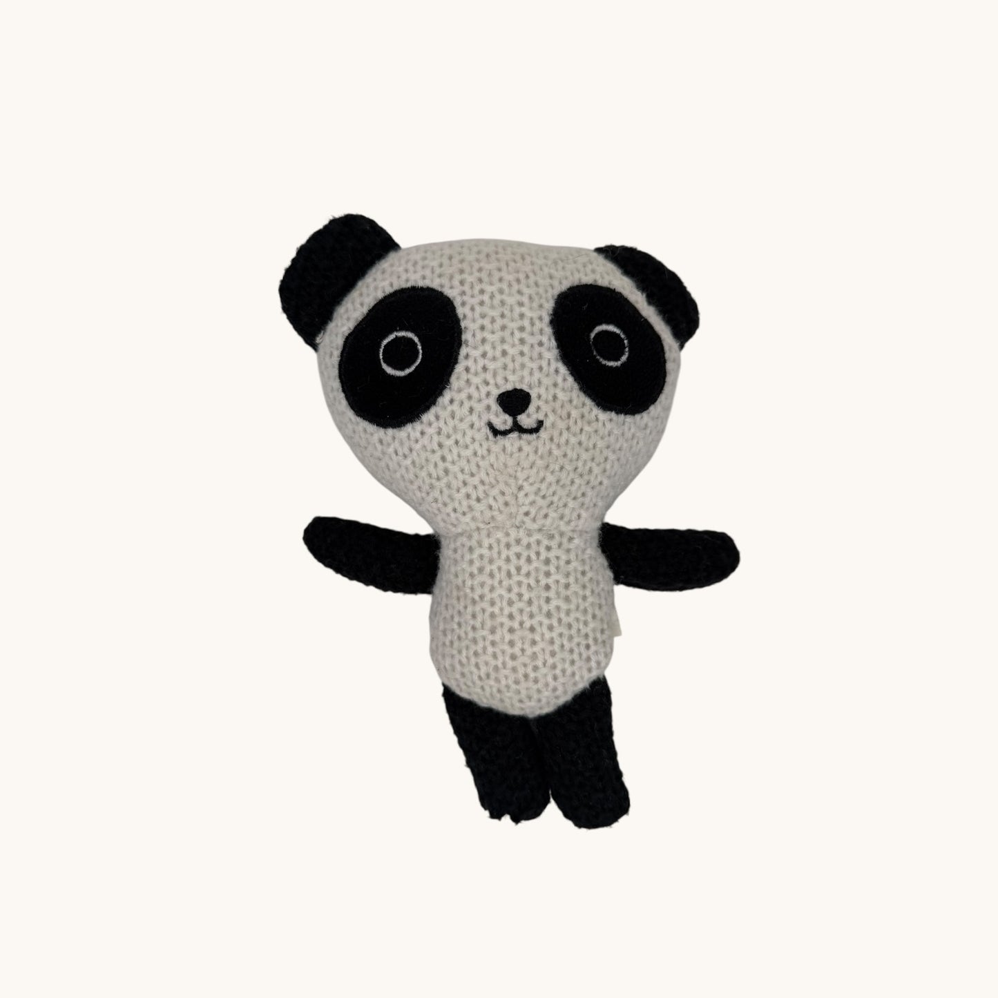 Knitted panda toy on a white background