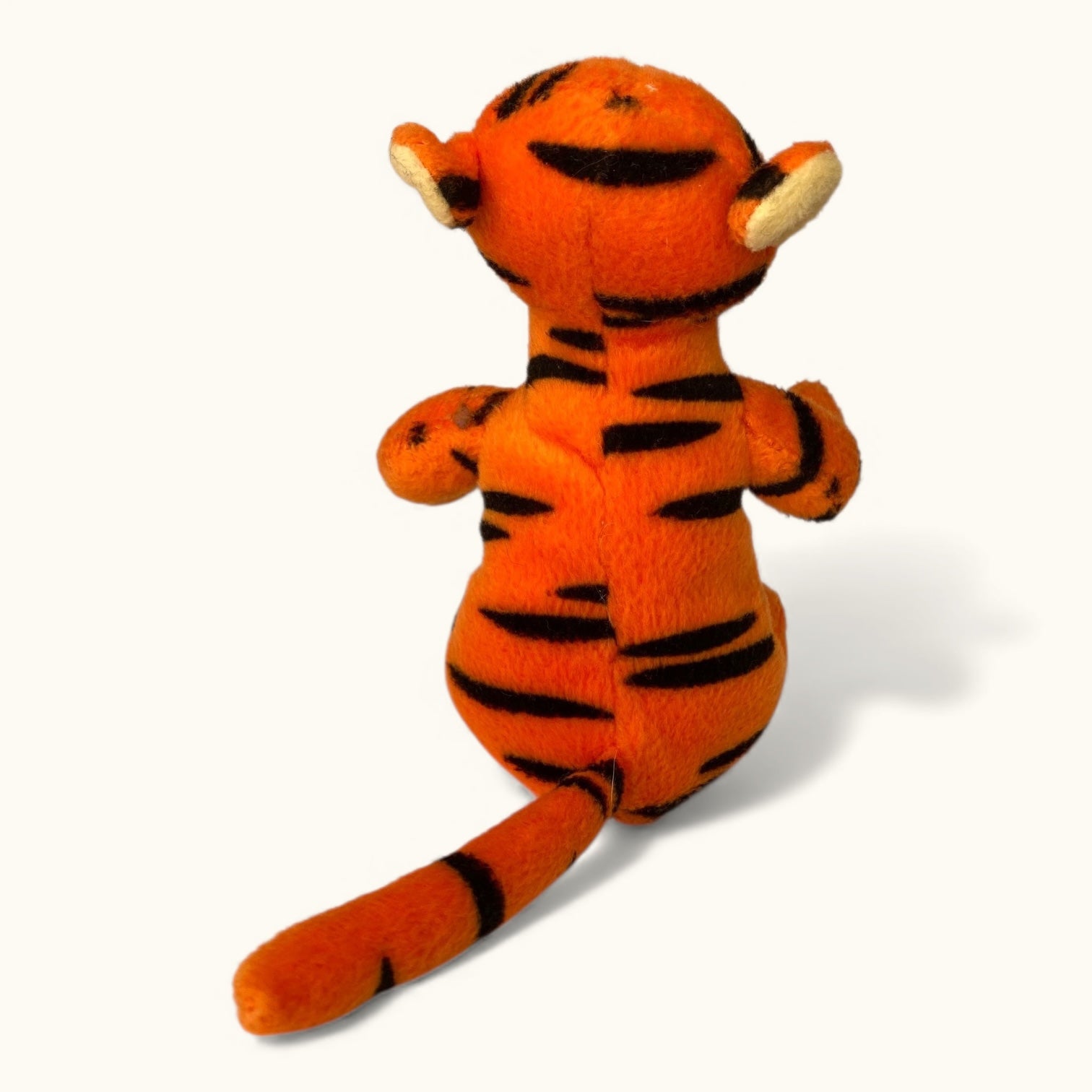 Plush tiger toy with black stripes on a white background