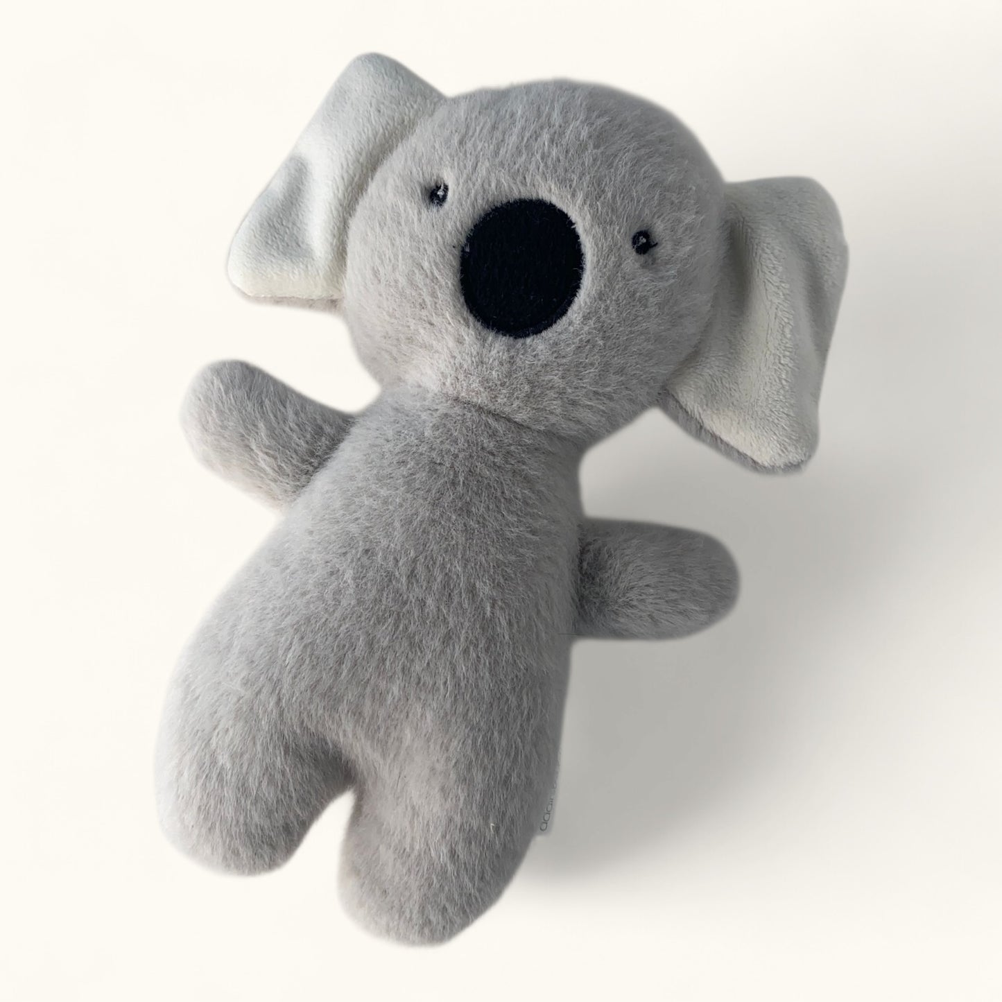 Gray plush koala toy on a white background