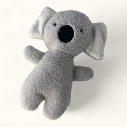 Gray plush koala toy on a white background
