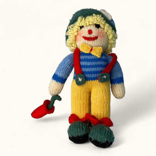 Knitted toy with a colorful outfit on a white background