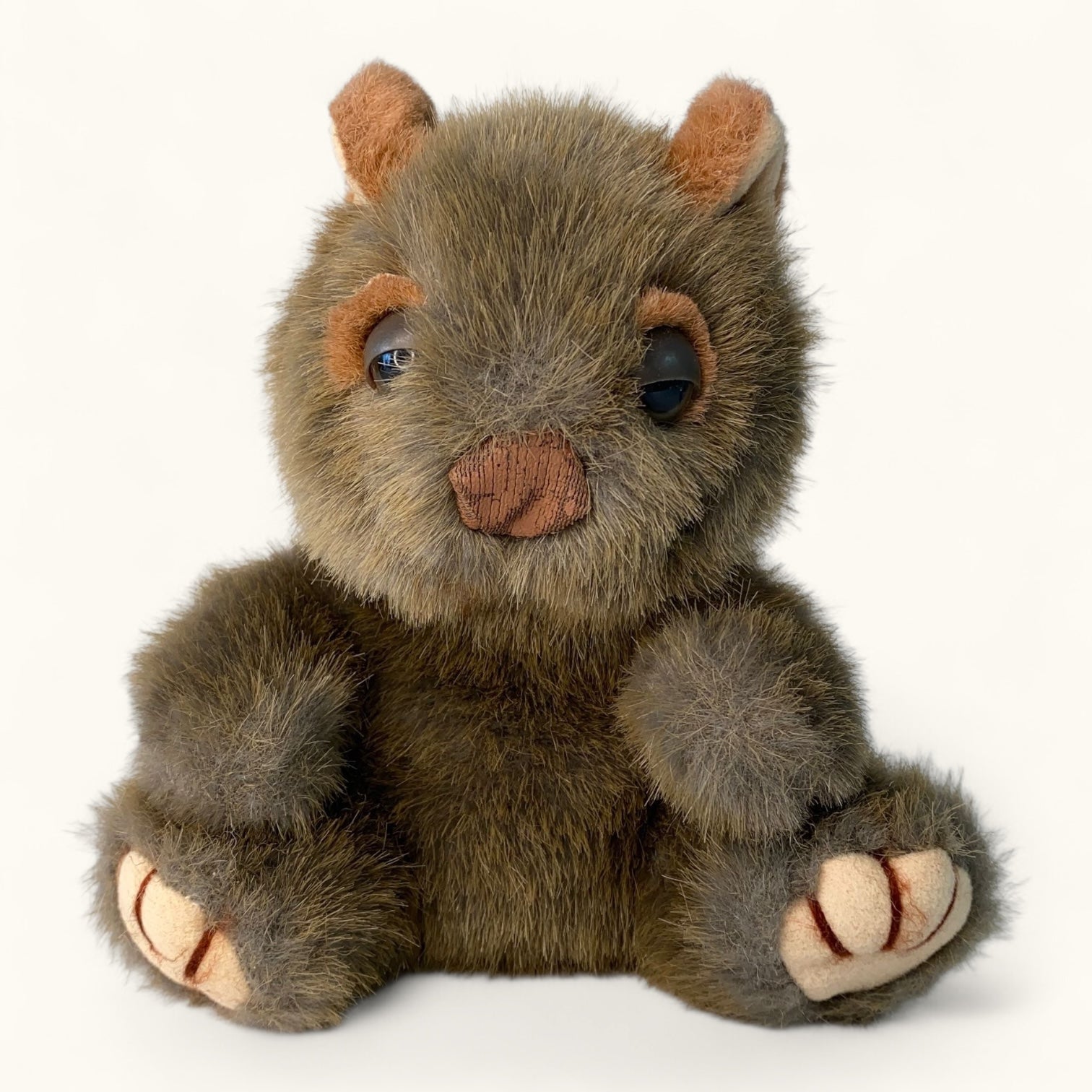 Plush toy wombat brown animal with large eyes on a white background