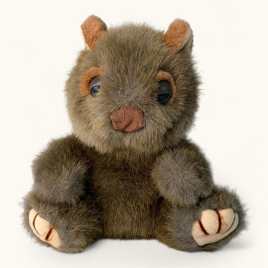 Plush toy wombat brown animal with large eyes on a white background