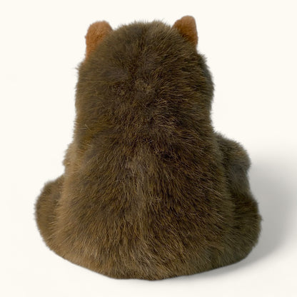 Plush toy wombat from behind on a white background
